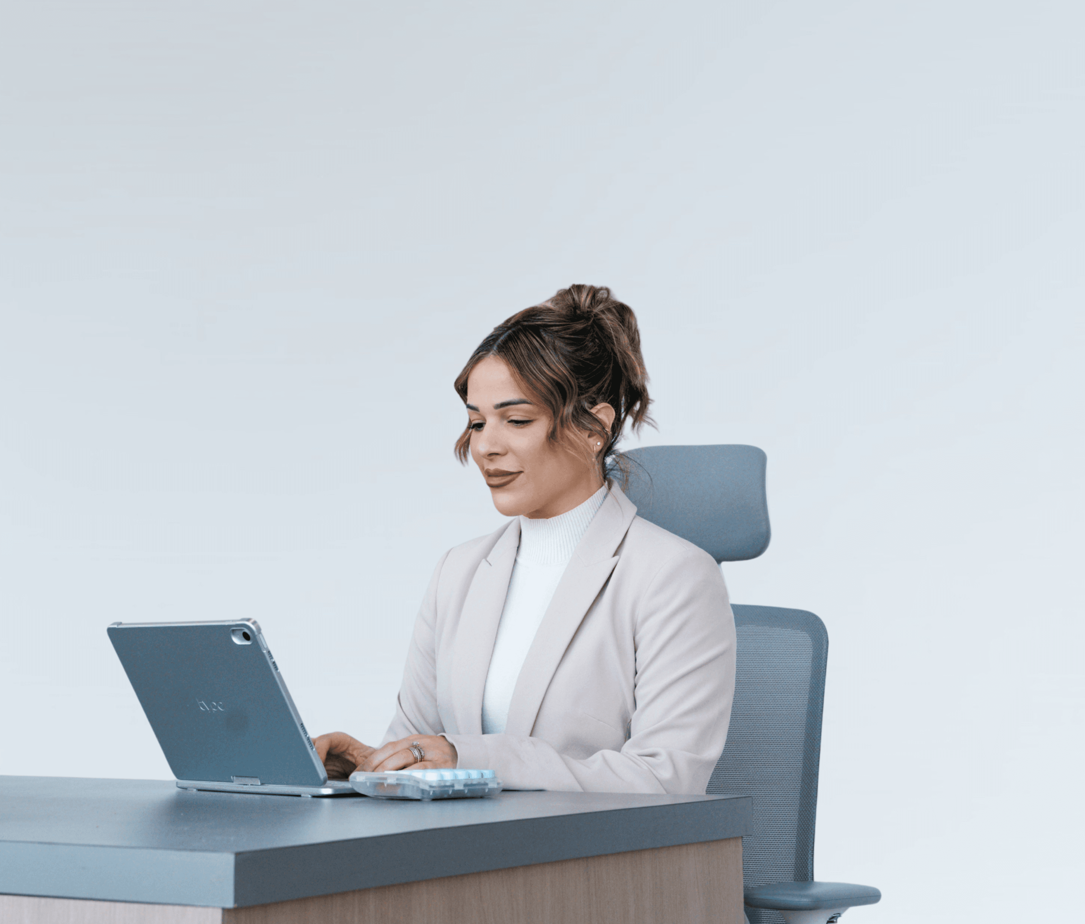 Face Forward Aesthetics team member working at a laptop