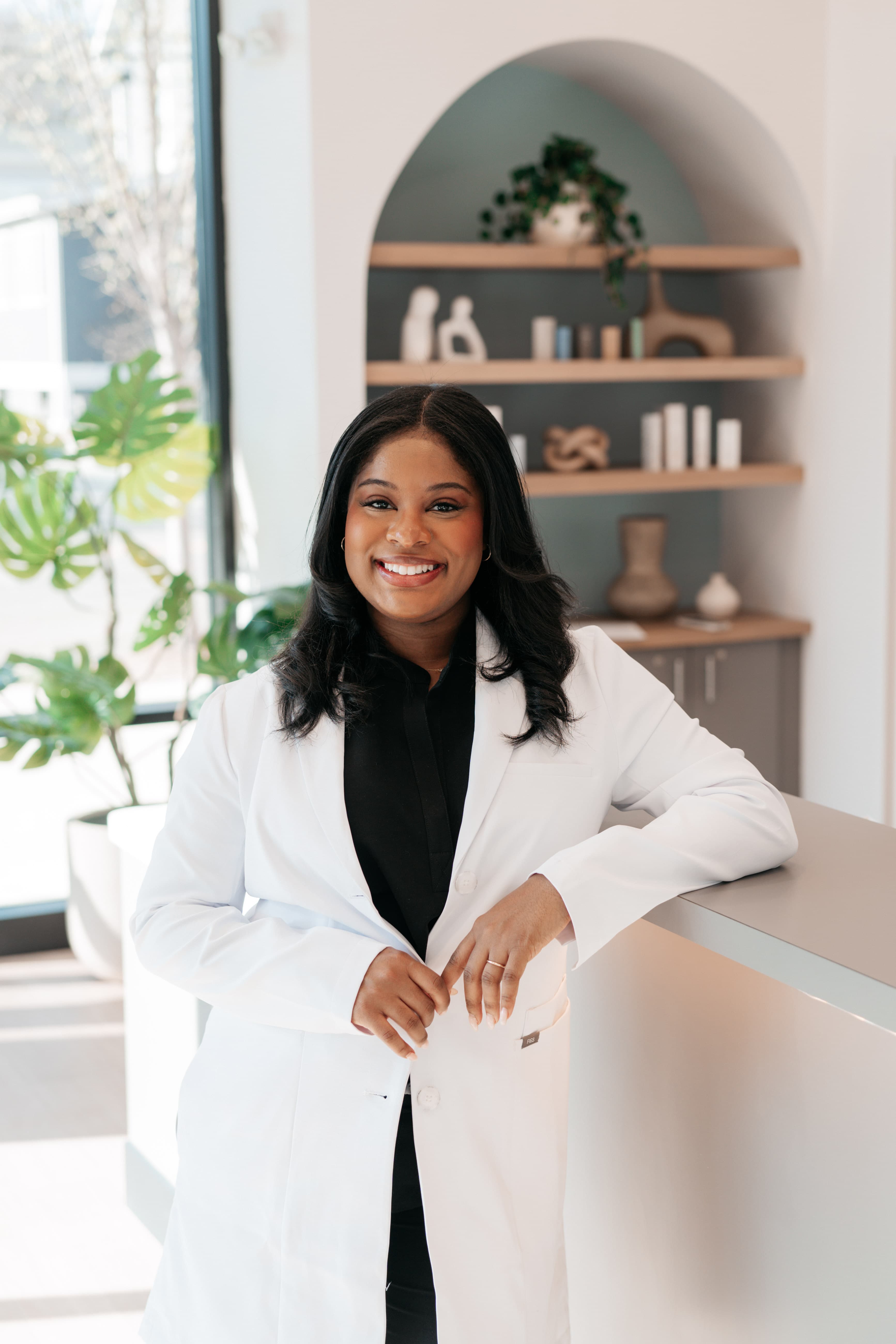 Face Forward Aesthetics nurse practitioner in a white coat at the clinic