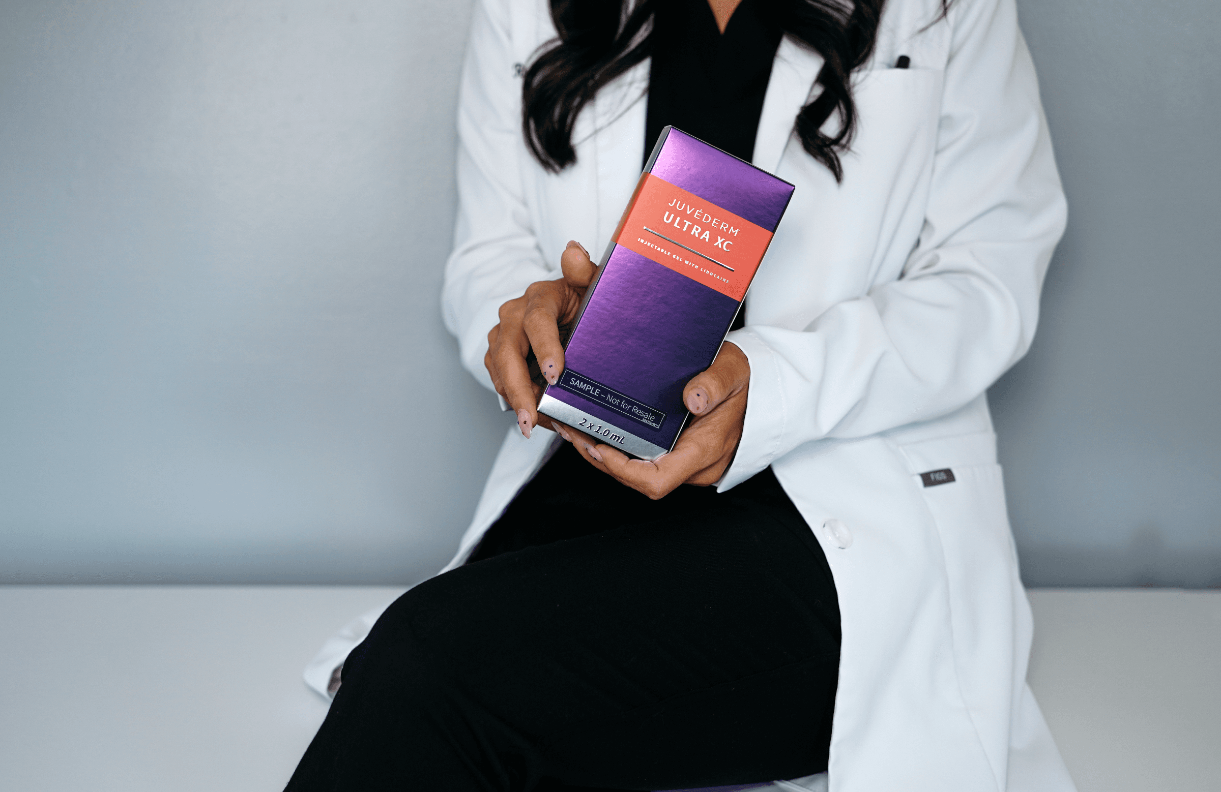 Face Forward Aesthetics provider holding a JUVÉDERM Ultra XC package